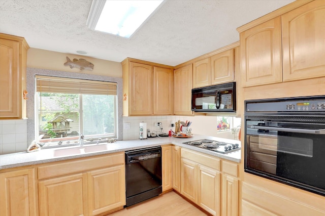 13227 N E Newman Lake Dr, Newman Lake, WA 99025 - kitchen featuring black appliances, light brown cabinets, a sink, light countertops, and a textured ceiling