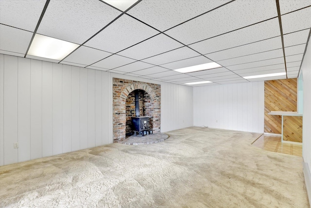13227 N E Newman Lake Dr, Newman Lake, WA 99025 - basement with a wood stove, carpet floors, a drop ceiling, and wooden walls