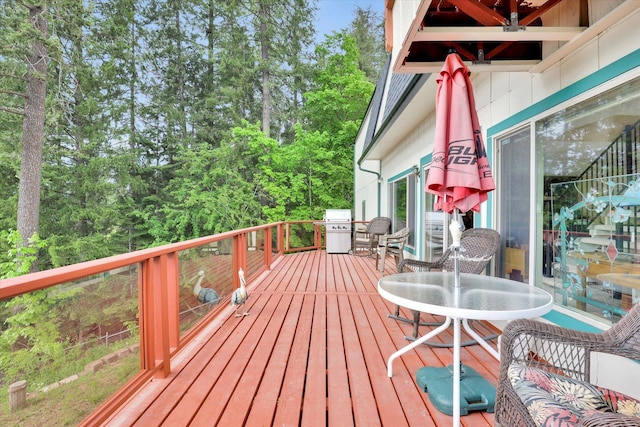 13227 N E Newman Lake Dr, Newman Lake, WA 99025 - deck with outdoor dining space and view of wooded area