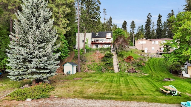 13227 N E Newman Lake Dr, Newman Lake, WA 99025 - view of green lawn with a storage unit and an outdoor structure