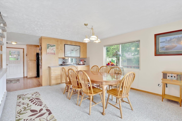13227 N E Newman Lake Dr, Newman Lake, WA 99025 - dining room with a chandelier, baseboards, and light colored carpet