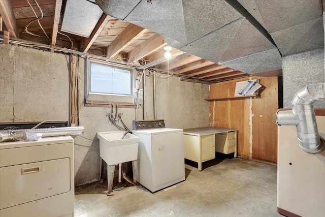 below grade area featuring washer and dryer and a sink