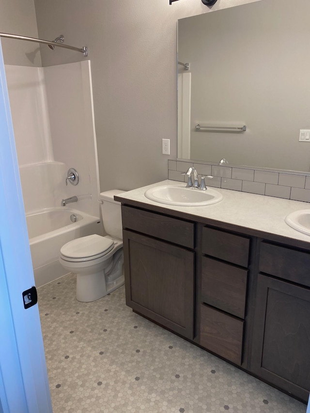 18718 E Riverside Ct, Spokane Valley, WA 99016 - bathroom featuring double vanity, toilet, tile patterned floors, and bathtub / shower combination