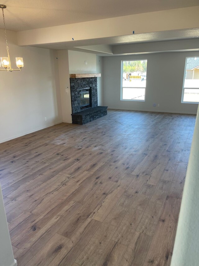18718 E Riverside Ct, Spokane Valley, WA 99016 - unfurnished living room with a chandelier, wood finished floors, and plenty of natural light