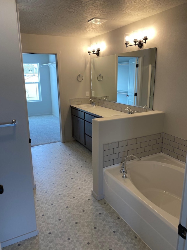 18718 E Riverside Ct, Spokane Valley, WA 99016 - full bath featuring a textured ceiling, tile patterned floors, a bath, and double vanity