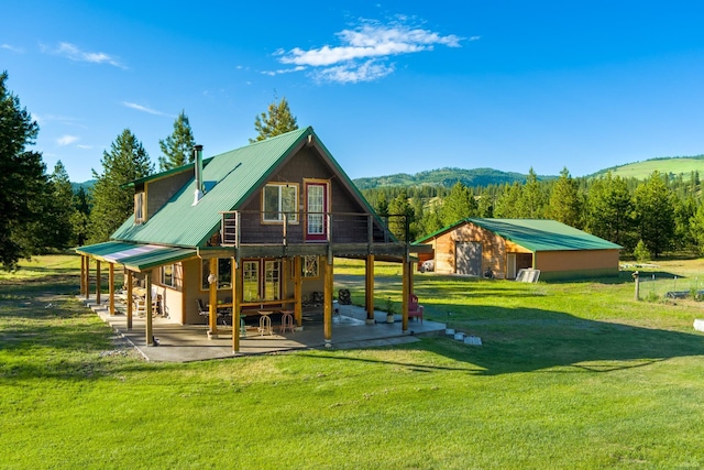 20 River Ranch Rd, Kettle Falls, WA 99141 - back of property with a patio, a yard, metal roof, and a view of trees