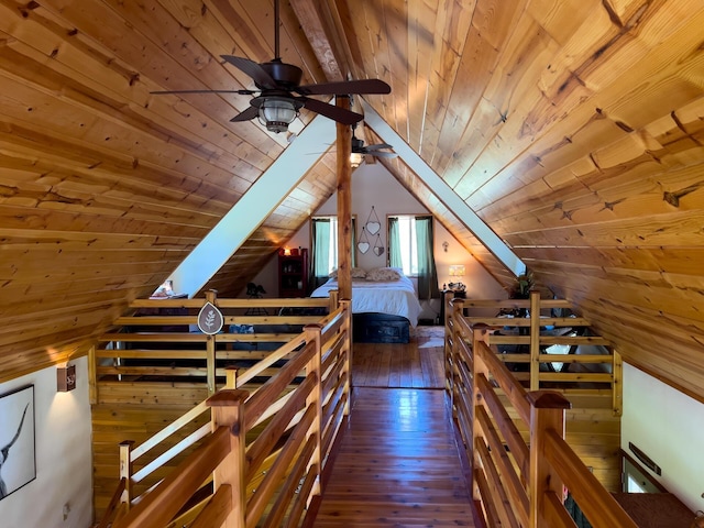 stairs with wooden ceiling, hardwood / wood-style floors, vaulted ceiling, and a ceiling fan