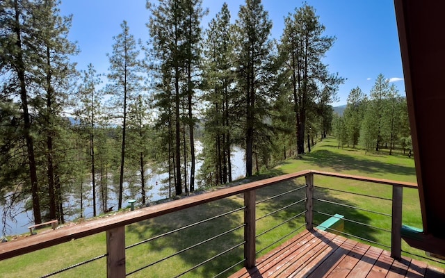 wooden deck featuring a lawn