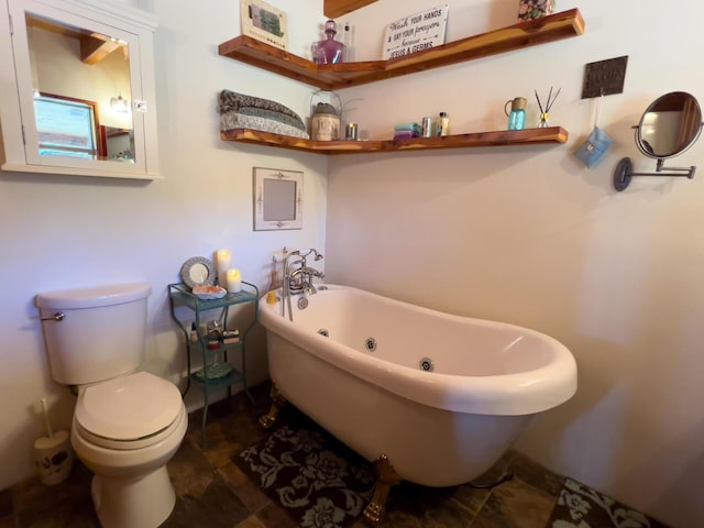 full bath featuring toilet and a freestanding tub