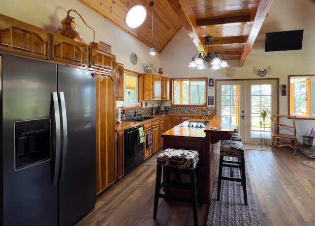 kitchen with black appliances, wood ceiling, brown cabinets, beamed ceiling, and french doors