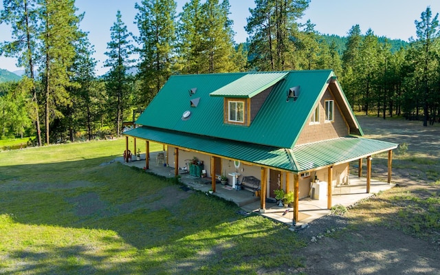 20 River Ranch Rd, Kettle Falls, WA 99141 - view of front of property featuring a front lawn, metal roof, and a patio