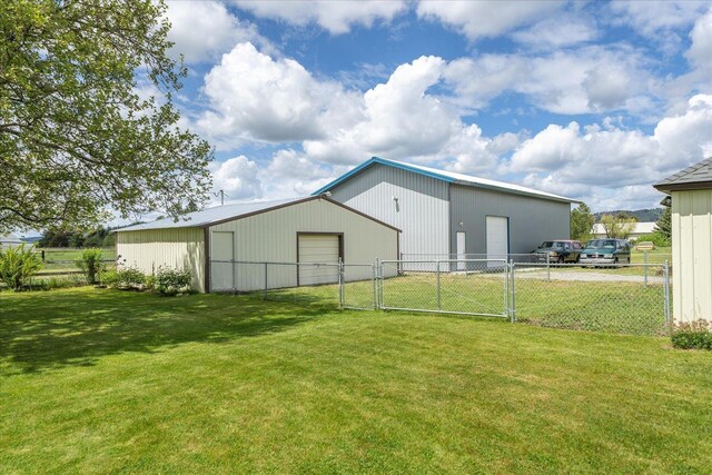 24005 E Garland Ave, Otis Orchards, WA 99027 - rear view of house featuring an outbuilding, a detached garage, and a gate