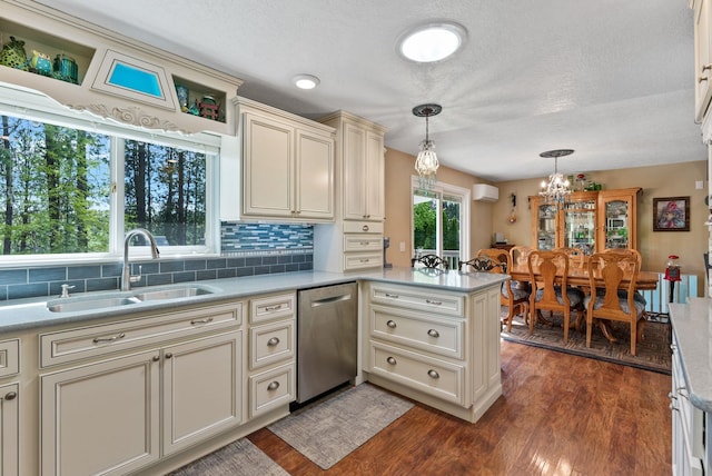 4109 S Hollow Ct, Spokane, WA 99206 - kitchen with dishwasher, a sink, a peninsula, light countertops, and hanging light fixtures