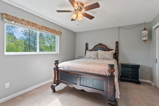 4109 S Hollow Ct, Spokane, WA 99206 - carpeted bedroom featuring multiple windows, baseboards, a textured ceiling, and ceiling fan