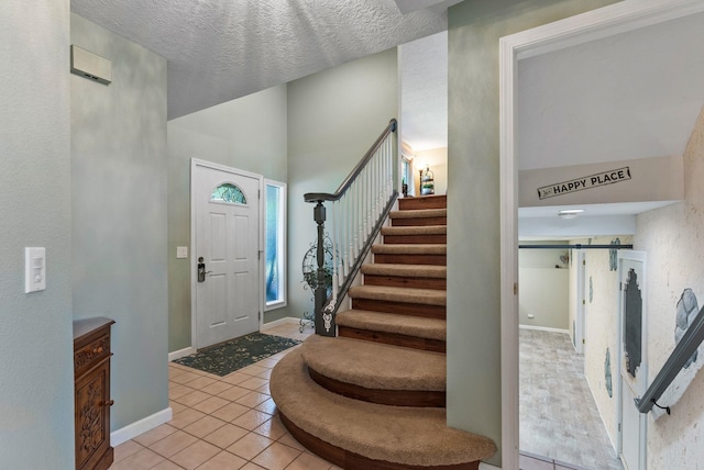4109 S Hollow Ct, Spokane, WA 99206 - foyer entrance with light tile patterned floors, stairs, and baseboards