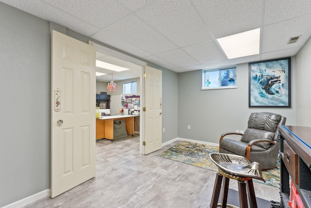 4109 S Hollow Ct, Spokane, WA 99206 - sitting room featuring light wood finished floors, a drop ceiling, and baseboards