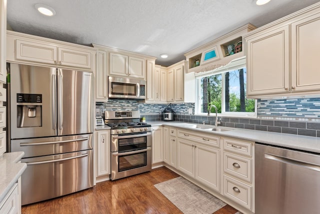 4109 S Hollow Ct, Spokane, WA 99206 - kitchen featuring appliances with stainless steel finishes, a sink, cream cabinets, light countertops, and recessed lighting