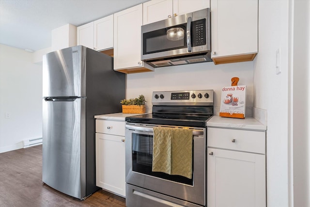 3424 W Princeton Ave, Spokane, WA 99205 - kitchen with appliances with stainless steel finishes, light countertops, dark wood-style floors, white cabinets, and baseboards
