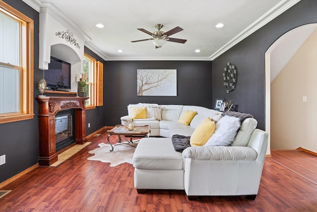 6482 Lakeview Dr, Nine Mile Falls, WA 99026 - living area featuring ceiling fan, a glass covered fireplace, recessed lighting, wood finished floors, and crown molding