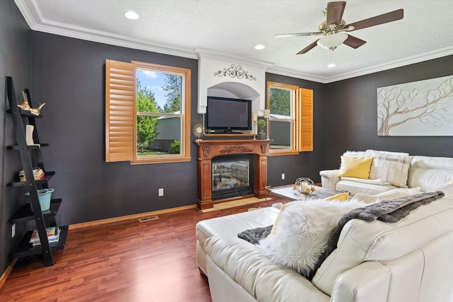 6482 Lakeview Dr, Nine Mile Falls, WA 99026 - living area featuring plenty of natural light, wood finished floors, ceiling fan, a fireplace with flush hearth, and ornamental molding