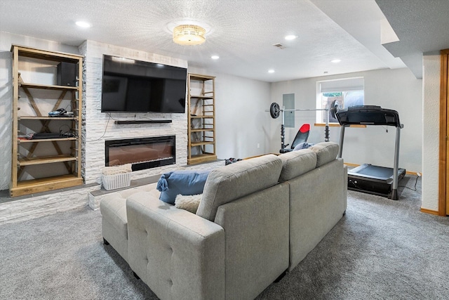 6482 Lakeview Dr, Nine Mile Falls, WA 99026 - living area with carpet floors, a textured ceiling, a stone fireplace, recessed lighting, and baseboards