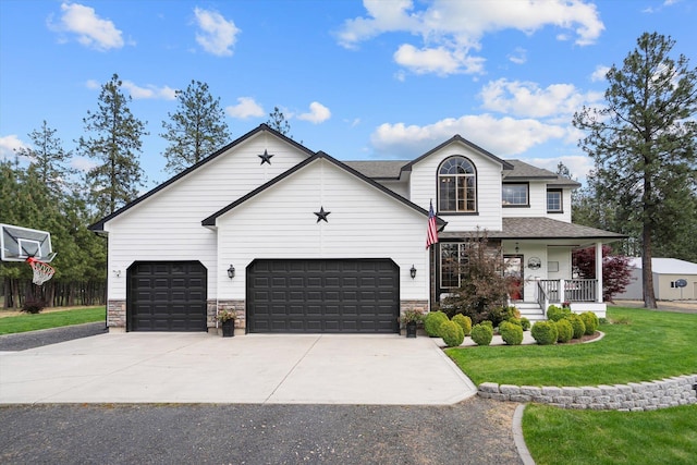 6482 Lakeview Dr, Nine Mile Falls, WA 99026 - view of front of home featuring concrete driveway, a front lawn, covered porch, roof with shingles, and a garage