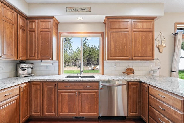 6482 Lakeview Dr, Nine Mile Falls, WA 99026 - kitchen with stainless steel dishwasher, a sink, decorative backsplash, light stone countertops, and recessed lighting