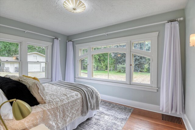 10228 N Whitworth Dr, Spokane, WA 99218 - bedroom with baseboards, wood finished floors, and a textured ceiling