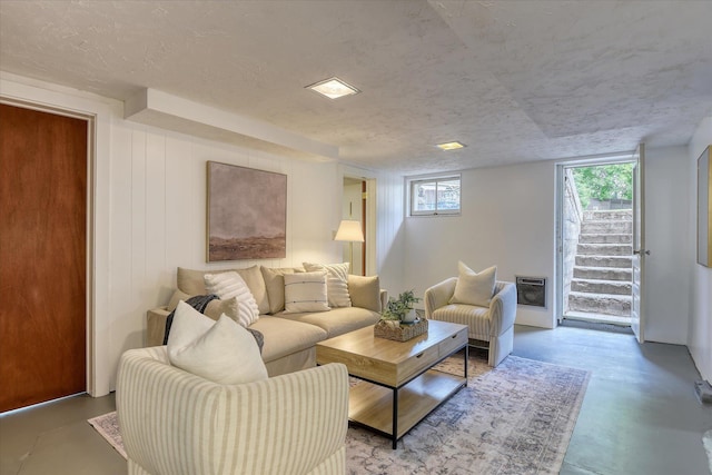 living area with concrete floors and heating unit