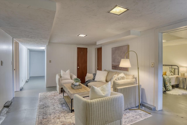 living area with concrete flooring and a textured ceiling