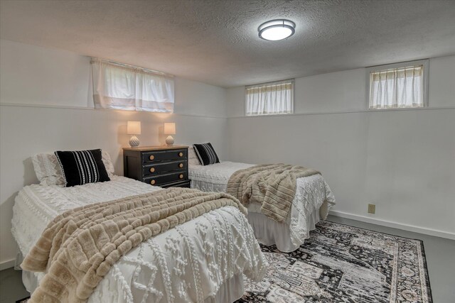 10228 N Whitworth Dr, Spokane, WA 99218 - bedroom with a textured ceiling and baseboards