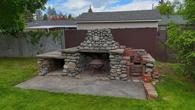 10228 N Whitworth Dr, Spokane, WA 99218 - view of front of house with stone siding, a chimney, a front yard, roof with shingles, and a patio