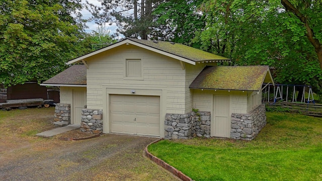 garage featuring asphalt driveway