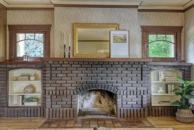 10228 N Whitworth Dr, Spokane, WA 99218 - living room with crown molding, wood walls, a brick fireplace, and a textured ceiling