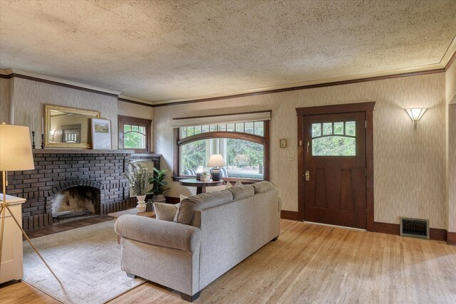 10228 N Whitworth Dr, Spokane, WA 99218 - living room with wood finished floors, plenty of natural light, ornamental molding, a brick fireplace, and a textured ceiling