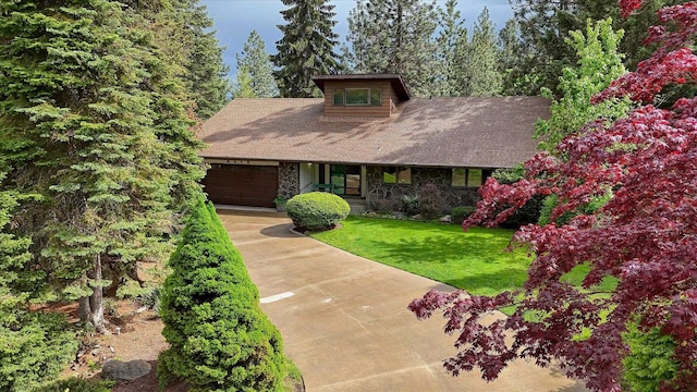 8410 E Columbia Park Dr, Spokane, WA 99212 - view of front of house with stone siding, a garage, concrete driveway, and a front lawn