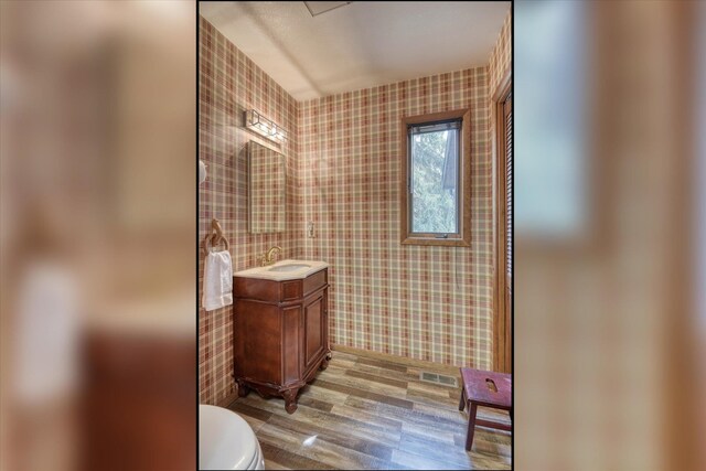 8410 E Columbia Park Dr, Spokane, WA 99212 - bathroom featuring wallpapered walls, toilet, vanity, and wood finished floors