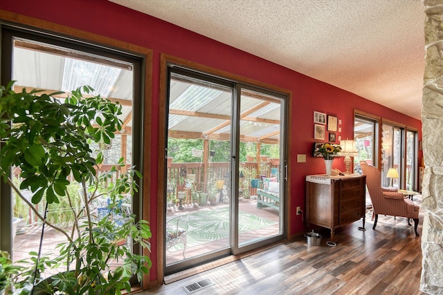 8410 E Columbia Park Dr, Spokane, WA 99212 - doorway featuring wood finished floors, a textured ceiling, and plenty of natural light