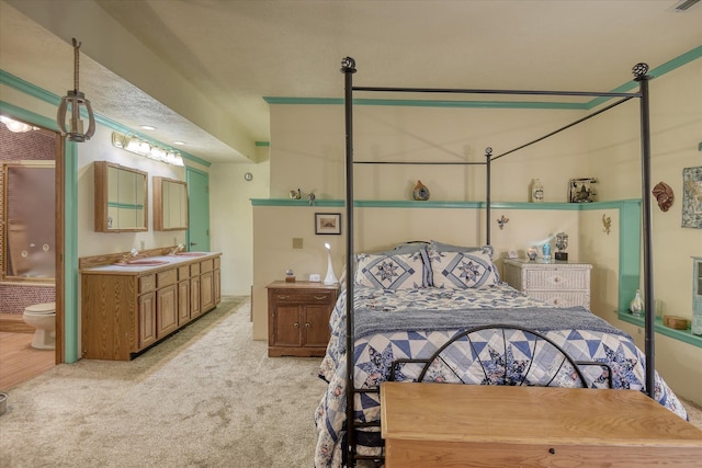 8410 E Columbia Park Dr, Spokane, WA 99212 - bedroom with a sink, light carpet, and connected bathroom