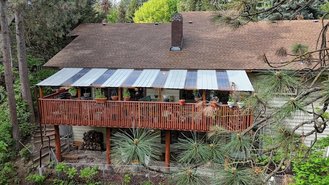 8410 E Columbia Park Dr, Spokane, WA 99212 - rear view of property with a chimney, roof with shingles, a deck, and metal roof