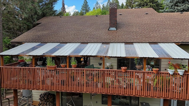 8410 E Columbia Park Dr, Spokane, WA 99212 - back of house featuring roof with shingles, a deck, and a chimney