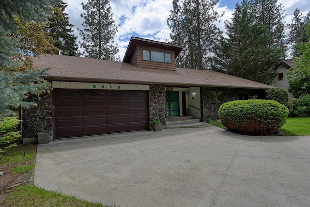 8410 E Columbia Park Dr, Spokane, WA 99212 - mid-century home with a garage, concrete driveway, stone siding, and a shingled roof
