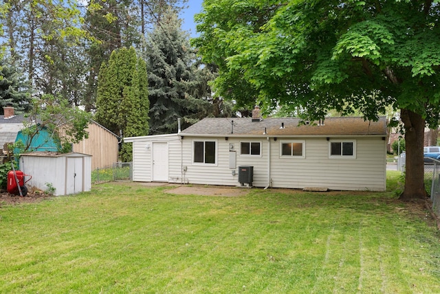 3123 E 36th Ave, Spokane, WA 99223 - back of property featuring a storage shed, cooling unit, an outbuilding, and a chimney