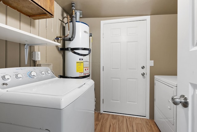 3123 E 36th Ave, Spokane, WA 99223 - laundry area with washing machine and clothes dryer, secured water heater, and light wood-type flooring