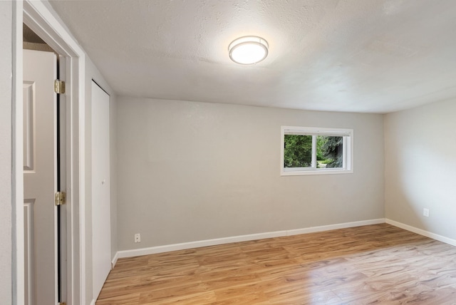 3123 E 36th Ave, Spokane, WA 99223 - spare room with light wood-type flooring, baseboards, and a textured ceiling