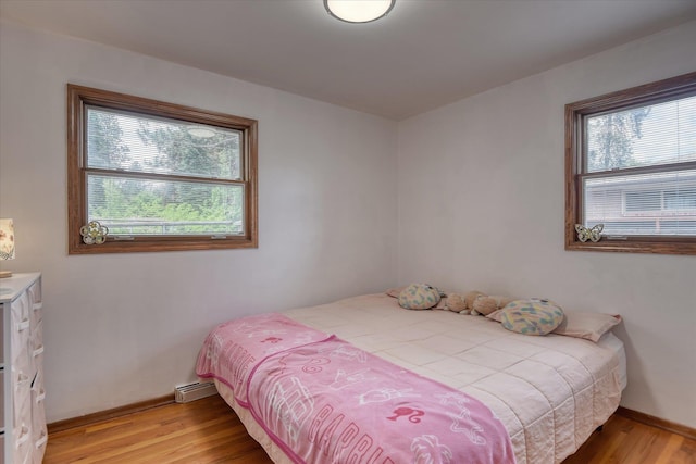 9509 N Atlantic St, Spokane, WA 99218 - bedroom featuring multiple windows, light wood-style flooring, and baseboards