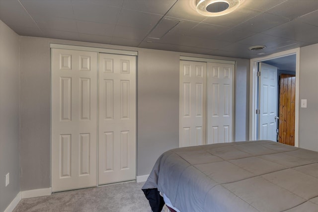 9509 N Atlantic St, Spokane, WA 99218 - bedroom with baseboards, carpet, and two closets