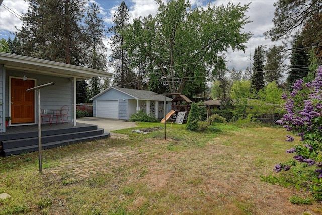 9509 N Atlantic St, Spokane, WA 99218 - view of grassy yard with an outdoor structure, a garage, and a deck