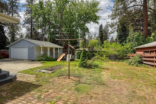 9509 N Atlantic St, Spokane, WA 99218 - view of yard with concrete driveway, a playground, and an outdoor structure