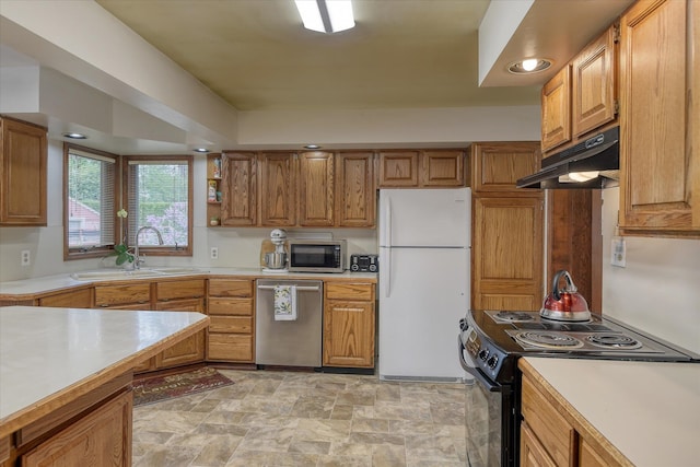 9509 N Atlantic St, Spokane, WA 99218 - kitchen with appliances with stainless steel finishes, under cabinet range hood, a sink, and light countertops